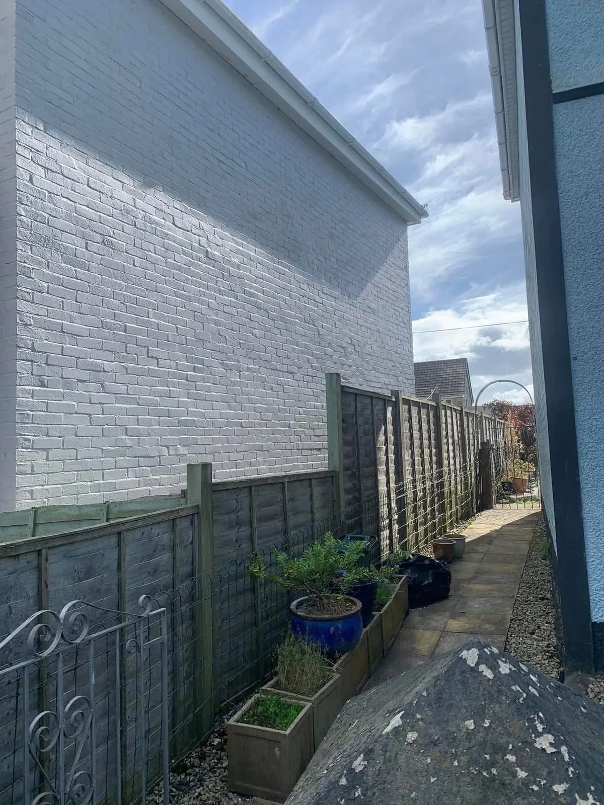 Freshly painted brick wall after preparation and masonry paint in Camborne
