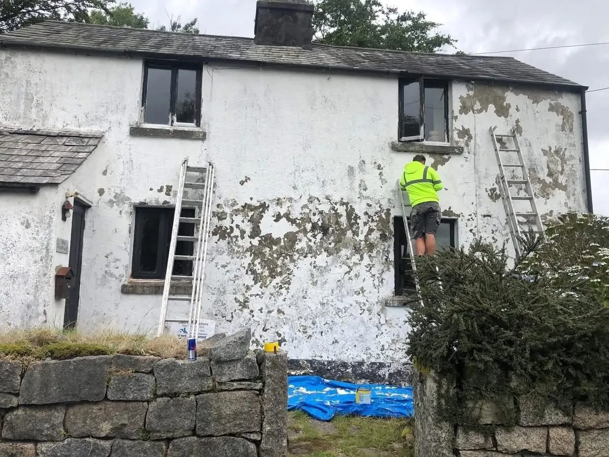 Cottage with blown, flaking render before repair in Camborne